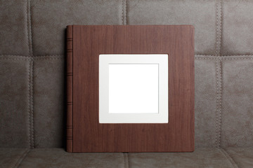 Family photo book with embossing. Photo book on a light background. Brown  photo book with  leather...