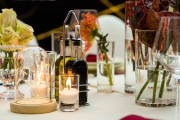 electric and natural candles and glass at the table setting
