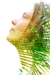 Double exposure profile of a happy natural beauty and bright shining tropical leaves which...