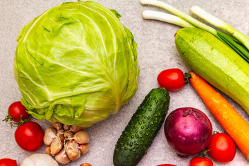 Assortment fresh organic vegetables. Food cooking stone background. Healthy vegetarian (vegan) eating concept, close up.