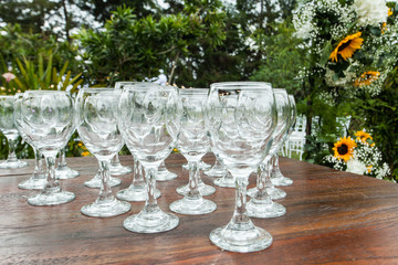 table with empty glass cups, ready to receive guests with a cocktail
