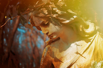 Close up guardian angel. Fragment of an antique statue.