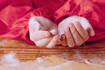 Fototapeta na wymiar Hands in flour as a symbol of food and сooking processt.
