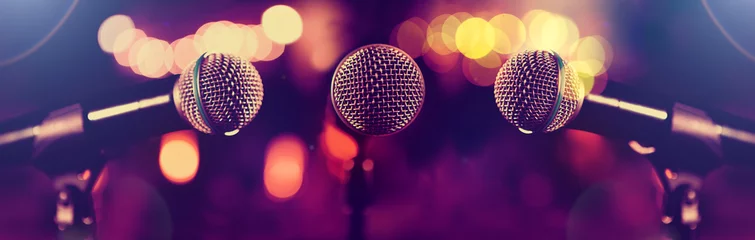 Poster Microphone and stage lights.Concert and music concept.Live music and conference background.Karaoke and entertainment concept. © C.Castilla