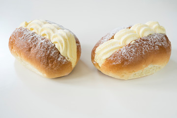 typical food from The Netherlands: creamed sandwich called roombroodje or puddingbroodje. Against white background. 