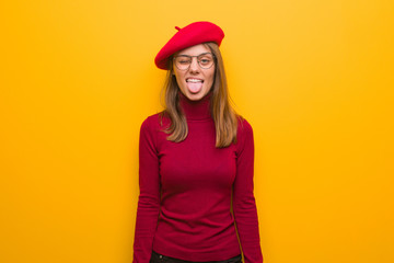 Fototapeta premium Young french artist woman funnny and friendly showing tongue