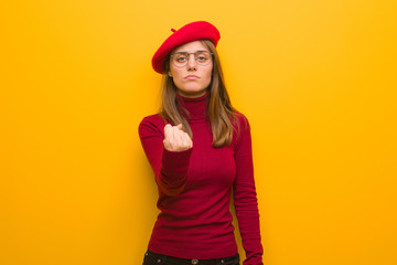 Naklejka premium Young french artist woman showing fist to front, angry expression