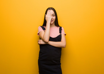 Young natural pretty girl shouting happy and covering face with hand