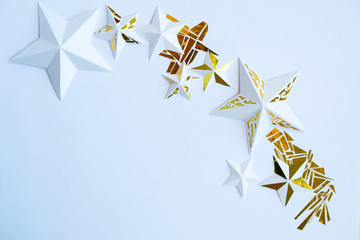Stars cut from white paper on white background