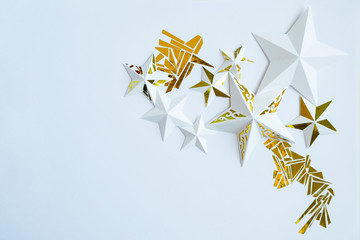 Stars cut from white paper on white background