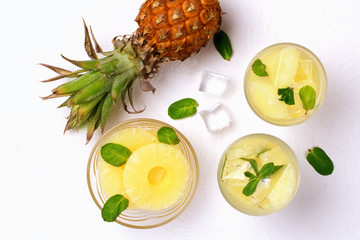 Infused water with pineapple and mint on whit background.