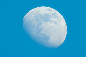 Moon in Waxing Gibbous phase on the daytime blue sky