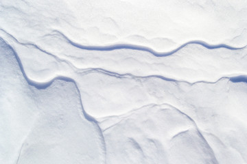 Snow textured background with thin mini crests/ridges going across like veins. Simple, minimalist, abstract Winter backdrop wallpaper with discrete shadow lines.