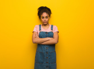 Young black african american girl with blue eyes crossing arms relaxed