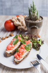 Two bruschettas, ginger, tomatoes and cactus