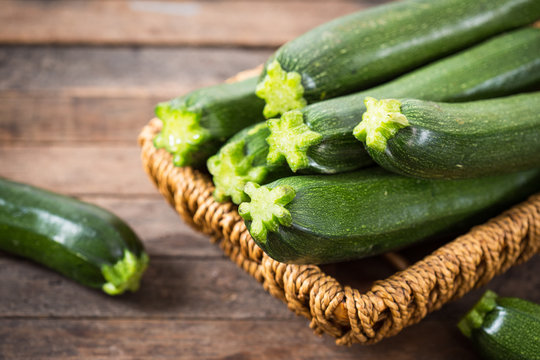 Fresh organic zucchini on the wooden table