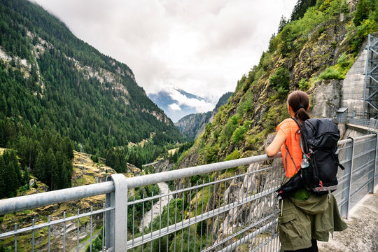 Switzerland, Valais, woman on a hiking trip from Blatten to Riederalm on a dam wall