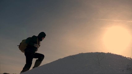 teamwork of business people. three climbers climb one after another on snow-covered hill. team of business people go to victory and success. people work together to overcome difficulties.