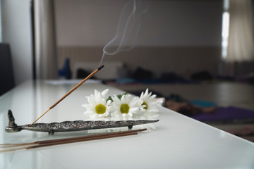 indian smoky aroma sticks with flowers and smoke