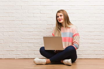 Young russian student woman sitting dreaming of achieving goals and purposes