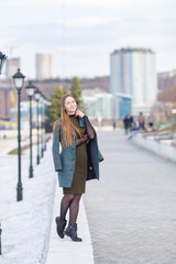 girl in a coat on the Volga river embankment in Cheboksary