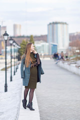 girl in a coat on the Volga river embankment in Cheboksary