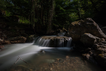 Obraz premium Mountain creek in moon light with long exposure