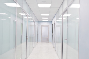 door glass plastic corridor, new office building, office rental, light blurred corridor background