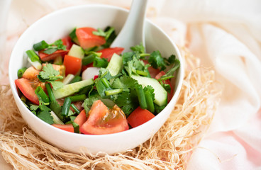 Tomatoes and cucumber, fresh vegetable salad in bowl.