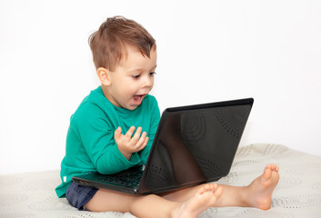 emotional boy with laptop on a light background