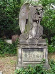 Obraz premium Tombstone with an angel statue on a deserted old cemetery, Czech Republlic, Olsany