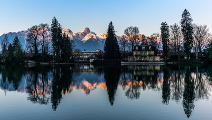 The Jungfrau and Eiger mountains reflecting the in the lake of Thun un Switzerland in the...