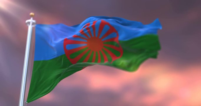 Flag of the Romani people at sunset. Loop