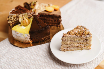Assortment of pieces of cake on messy table, copy space. Several slices of delicious desserts, restaurant menu concept, top view © ANR Production