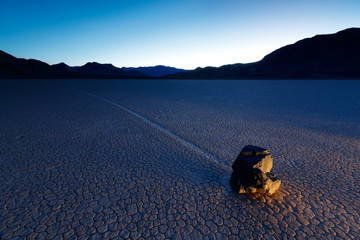 Lightpainting at The Racetrack in Death Valley National Park. The area gets its name from the once mysterious tracks which are the result of periodic winter storms over many years that brought moisture to the playa followed by cold night time temperatures which then formed thin sheets of ice and then are pushed by high winds, nudging the boulders a little at a time and creating these remarkable tracks.