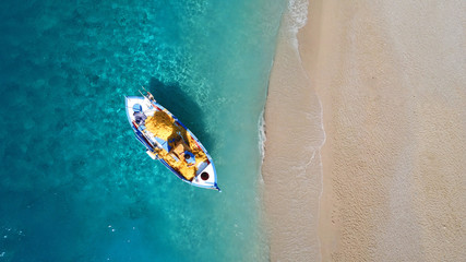 Fototapeta na wymiar Aerial drone top view photo of red wooden traditional fishing boat in turquoise sea shore of Zakynthos island, Ionian, Greece