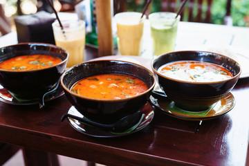 Tom Yam is a traditional thai soup, dish number 1 in Thai cuisine on wooden table