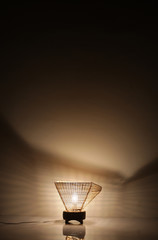 Fototapeta na wymiar Handmade wooden lamp on brown background