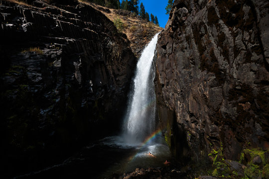 Two women escape the summer heat, swimming below the Middle Falls at Elk Creek Falls in northern Idaho in the Nez Perce - CLearwater National Forest. The 2 mile loop trail (the remnants of an old wagon trail), takes you to Upper, Middle, and Lower Elk Creek Falls.