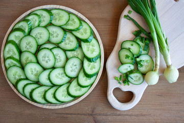 Light sandwiches with cheese, a tray with slices of fresh cucumber, onion, dill