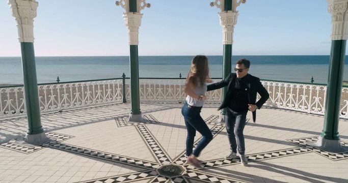 Aerial view of Caucasian young couple dancing salsa in the Victorian bandstand in Brighton