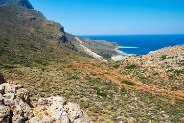 Climb to the top of the mountain. Journey to the ocean on arid land. Thorny shrubs. Greece, Crete. - 262093391