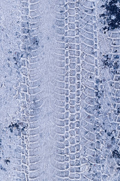tracks of vehicle tyres in white snow. background, seasoned.