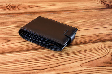black, men's wallet on a wooden background
