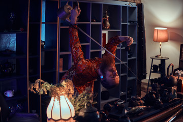 Chinese tea ceremony. Caucasian master in kimono making natural tea in the dark room with a wooden interior, using a teapot with a long spout. Tradition, health, harmony. Chinese tea ceremony