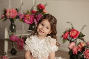 cute sweet girl 4-5 years old in a beautiful pink lace dress with flowers, portrait of a girl