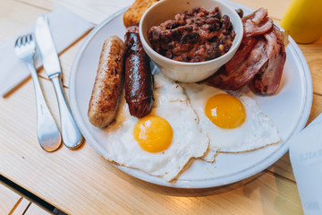 Breakfast with bacon, sausage, egg, beans and mushrooms