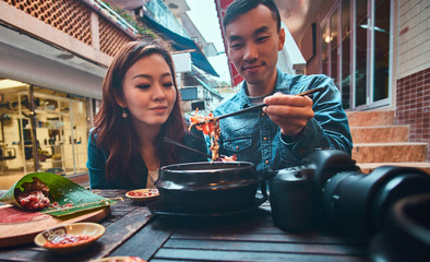 Asian couple are eating at chinese cafe