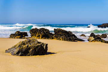 Fototapeta na wymiar Portugals sandy beach on rocky Atlantic coast. Adraga beach.