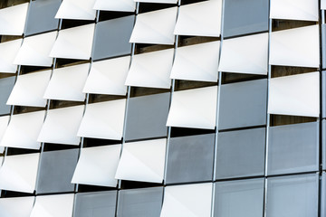 Decorative curved and perforated elements of the outer wall of modern high-rise building